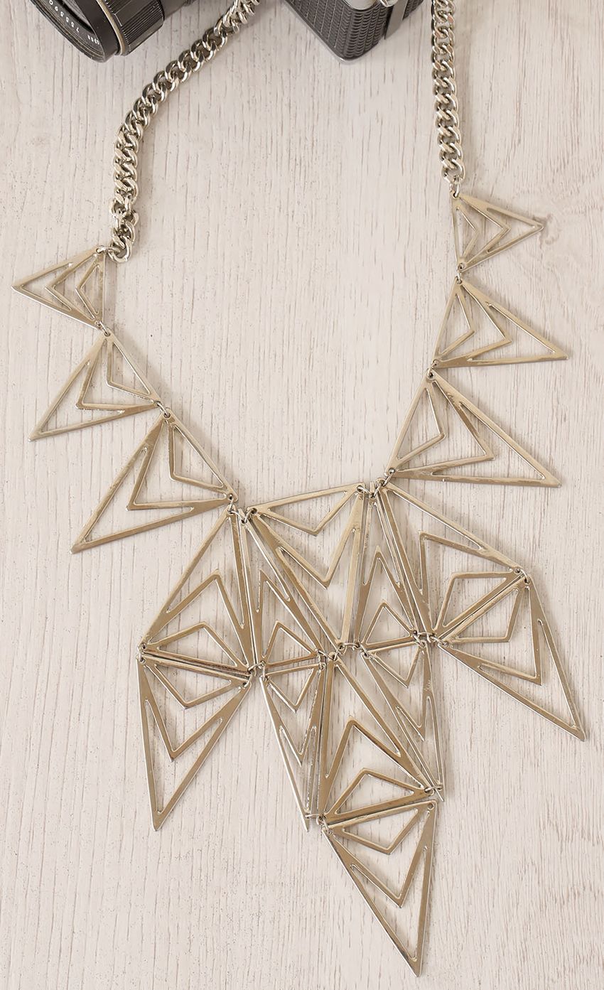 Picture Silver Triangle Cut-Out Necklace. Source: https://media-img.lucyinthesky.com/data/Apr15_1/850xAUTO/0Y5A6203.JPG