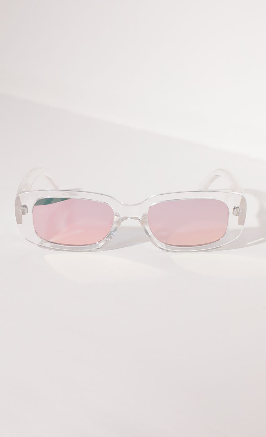 Picture Beverly Rectangular Retro Sunglasses in Clear with Pink Lenses. Source: https://media-img.lucyinthesky.com/data/Apr21_1/850xAUTO/AT2A0947.JPG