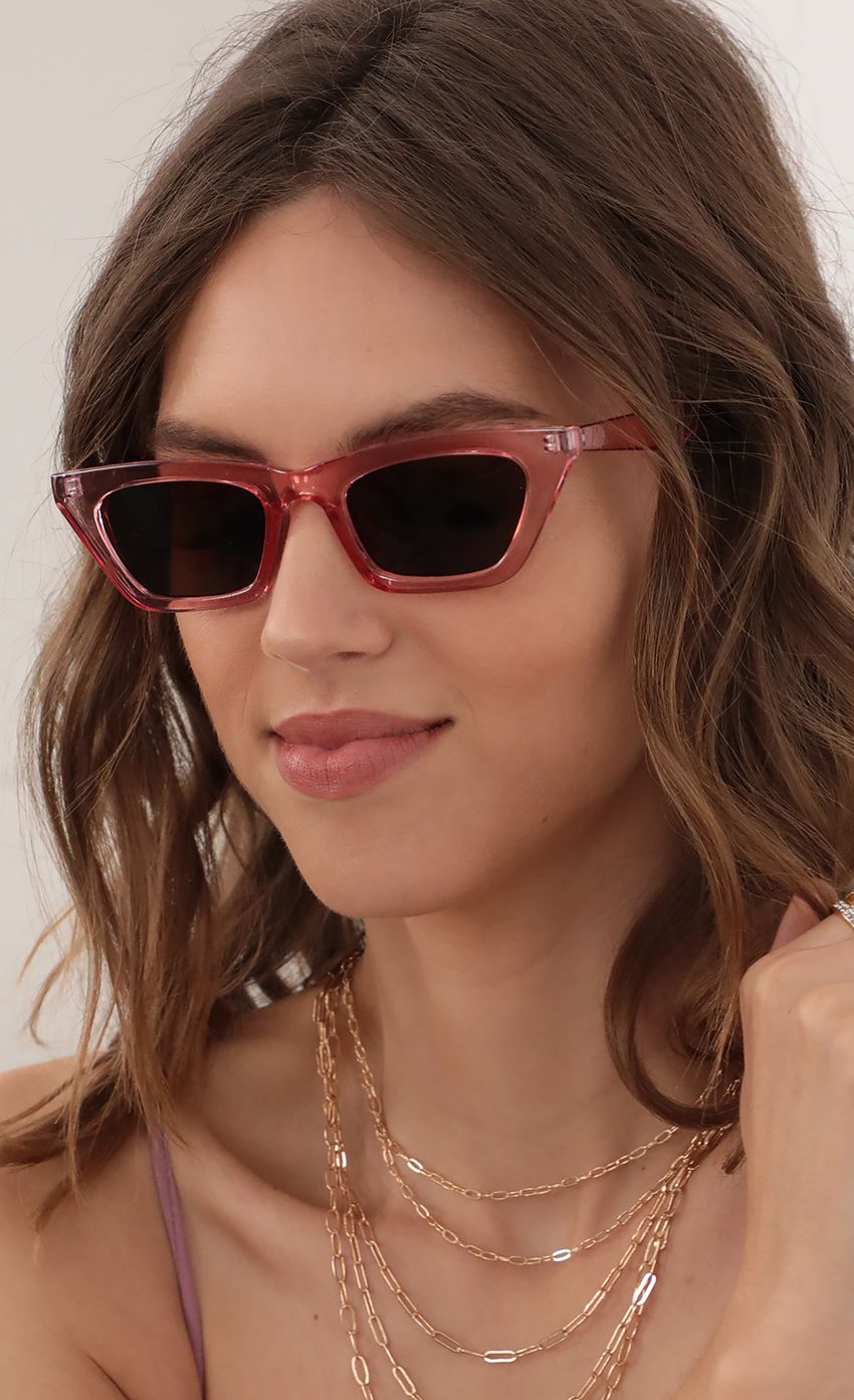 Picture Skinny Cat Eye Sunglasses in Clear Fucsia. Source: https://media-img.lucyinthesky.com/data/Apr21_1/850xAUTO/AT2A4493.JPG