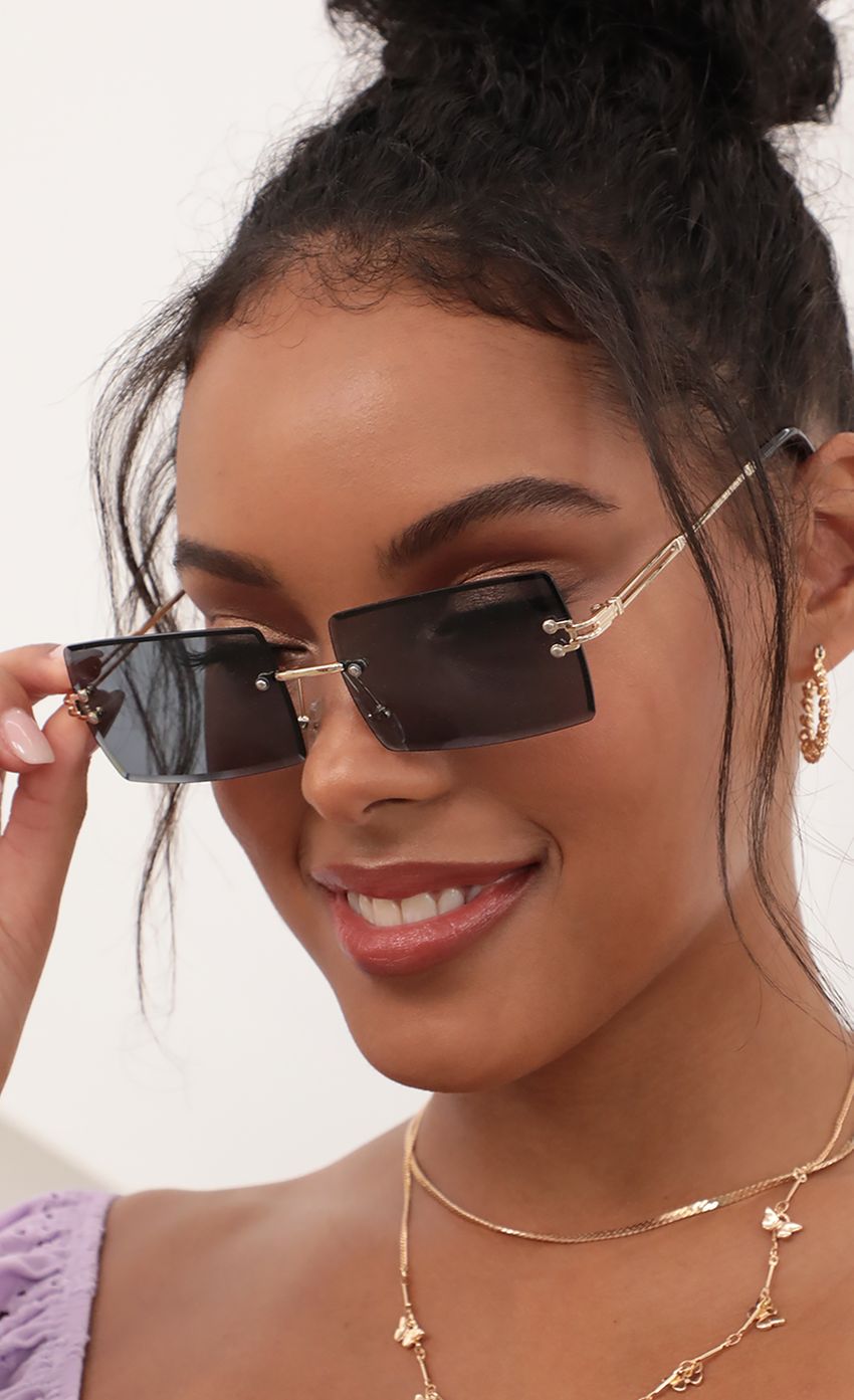 Picture 90s Baby Rectangle Sunglasses in Black. Source: https://media-img.lucyinthesky.com/data/Apr21_2/850xAUTO/AT2A2237.JPG