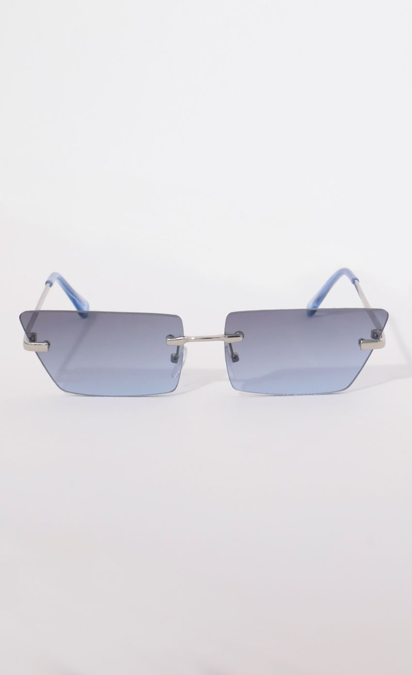 Picture Fairfax Rimless Sunglasses in Blue. Source: https://media-img.lucyinthesky.com/data/Apr21_2/850xAUTO/AT2A9079.JPG