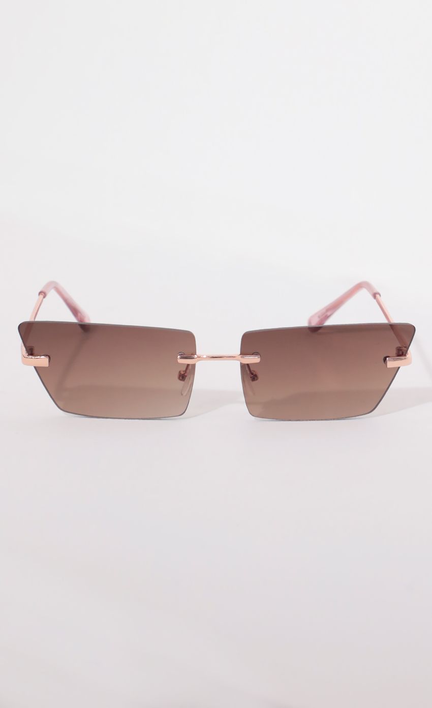 Picture Fairfax Rimless Sunglasses in Brown. Source: https://media-img.lucyinthesky.com/data/Apr21_2/850xAUTO/AT2A9081.JPG