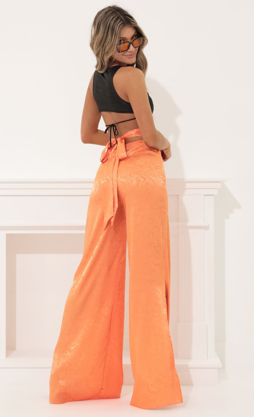 Picture Wide Leg Pants in Orange. Source: https://media-img.lucyinthesky.com/data/Apr22_2/850xAUTO/1V9A5397.JPG