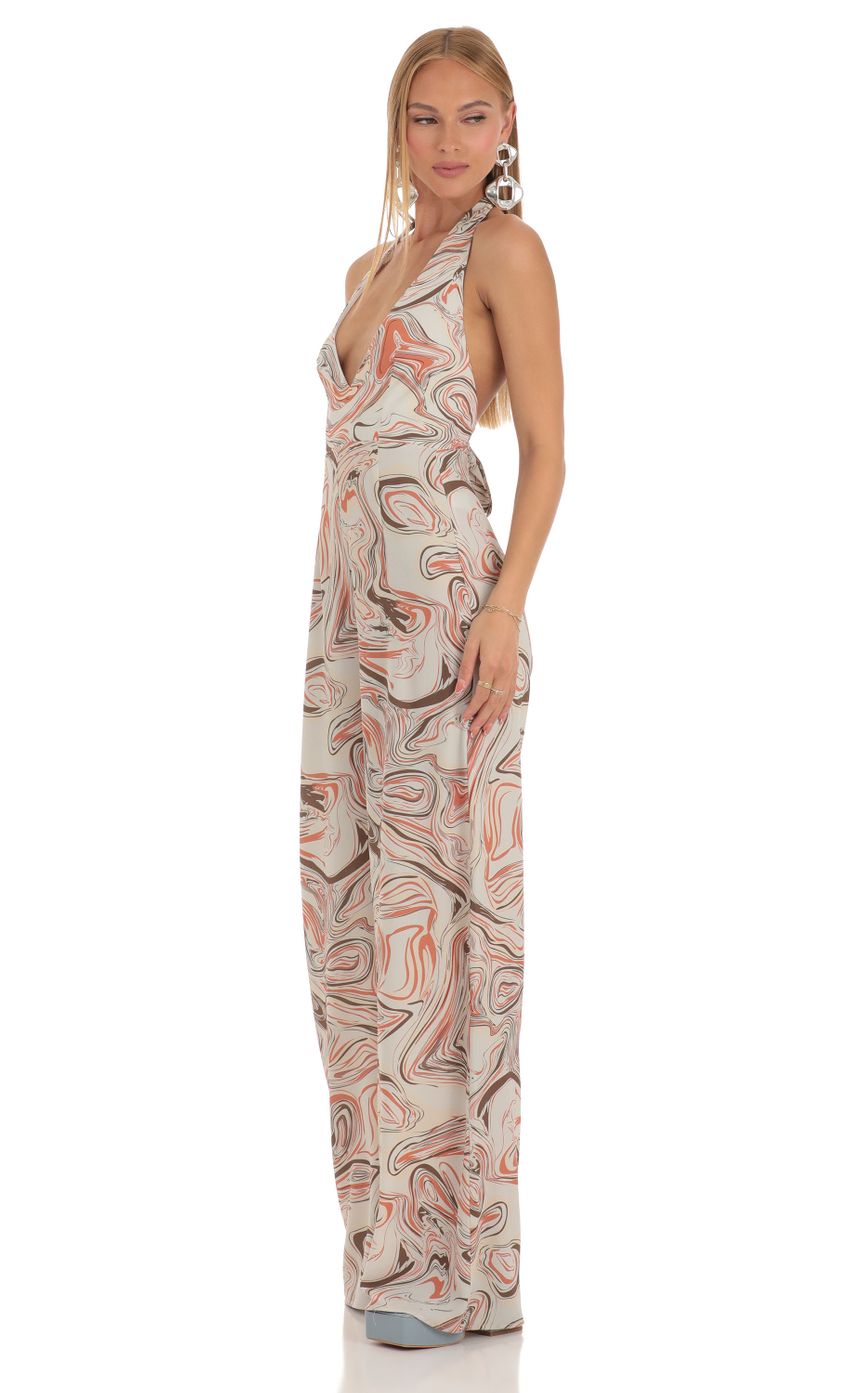 Picture Tymia Jumpsuit in Orange Swirl. Source: https://media-img.lucyinthesky.com/data/Apr23/850xAUTO/8cdfea97-0a20-4d5a-985c-d5421675031e.jpg