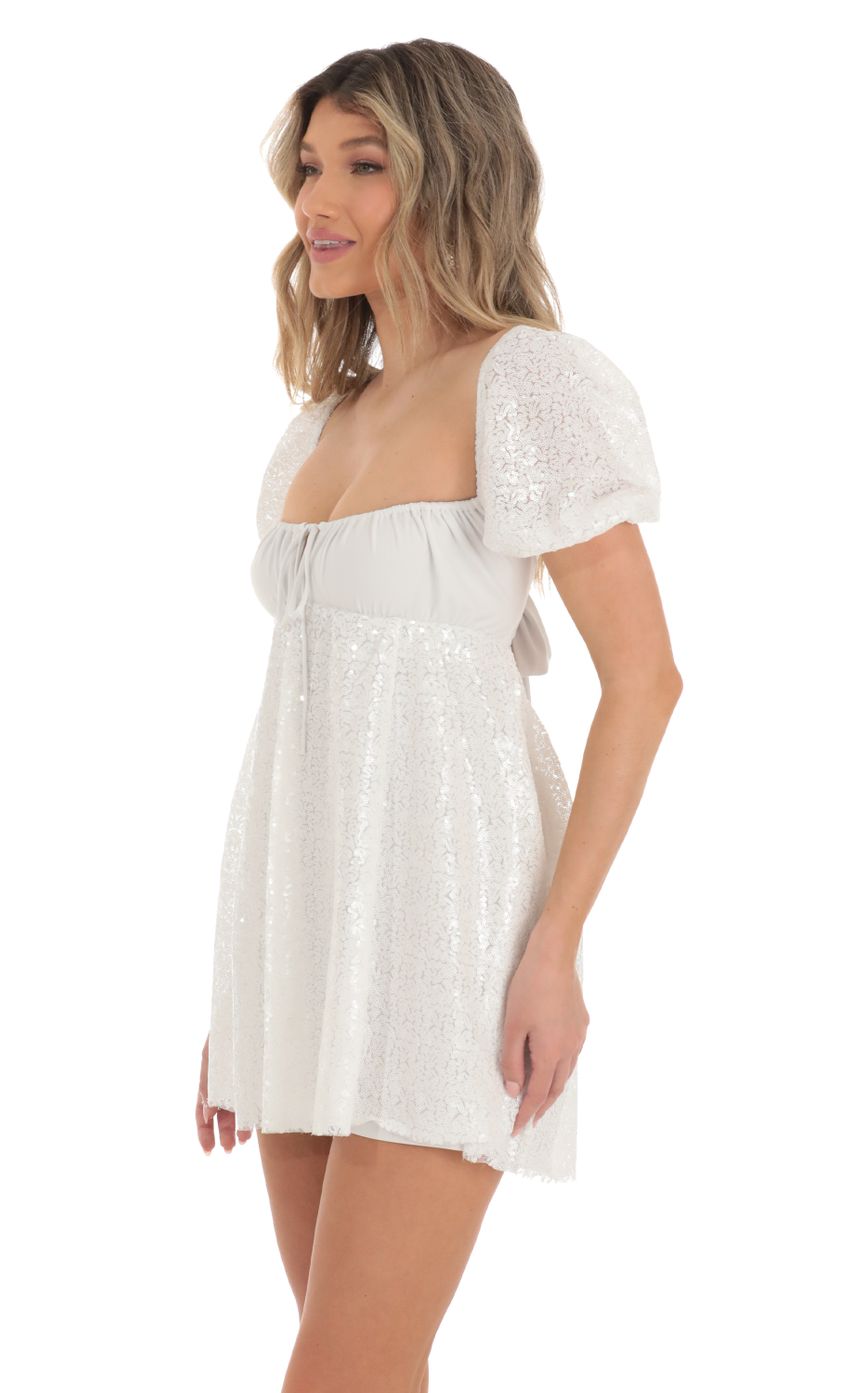 Picture Sequin Puff Sleeve Baby Doll Dress in White. Source: https://media-img.lucyinthesky.com/data/Apr23/850xAUTO/a8b09e55-c0ec-40ee-ae93-4093ec2f3aaf.jpg