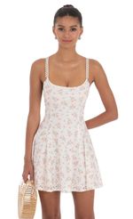 Picture Floral Strap Crossback Fit and Flare Dress in White. Source: https://media-img.lucyinthesky.com/data/Apr24/150xAUTO/1d559f00-13e9-48c9-9485-383c5fc093b9.jpg