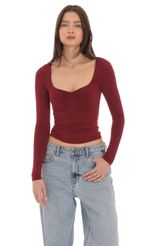 Picture Fitted Long Sleeve Top in Maroon. Source: https://media-img.lucyinthesky.com/data/Apr24/150xAUTO/405fcaab-824d-4557-b4e2-4e22a0986890.jpg