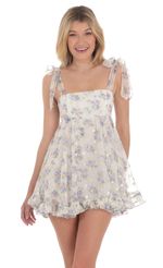 Picture Foiled Floral Ruffle Babydoll Dress in White. Source: https://media-img.lucyinthesky.com/data/Apr24/150xAUTO/97fe7561-d813-4d47-9f75-b97a6a4c6f4a.jpg