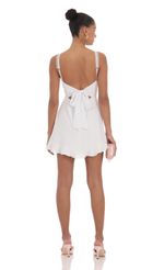 Picture Lace Strap Open Back Dress in White. Source: https://media-img.lucyinthesky.com/data/Apr24/150xAUTO/b1f3ad6d-f96a-4516-ba96-bdbe6247c638.jpg