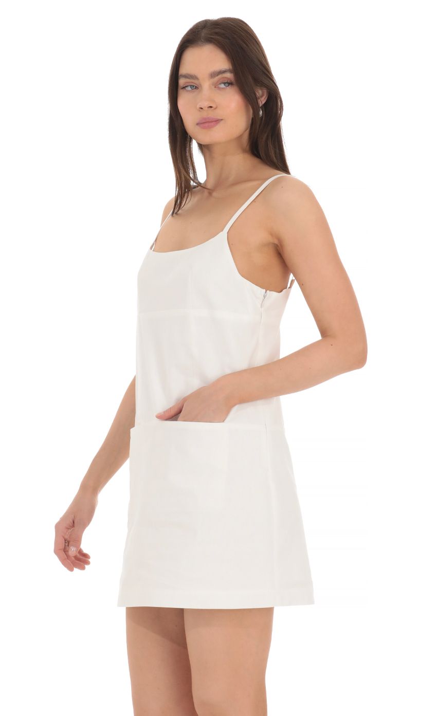 Picture Front Pocket Dress in White. Source: https://media-img.lucyinthesky.com/data/Apr24/850xAUTO/26e2d4c0-1da8-47bb-92fe-d10dcdaabf8d.jpg