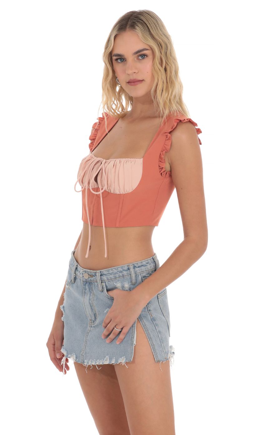 Picture Two Toned Ruffle Top in Orange. Source: https://media-img.lucyinthesky.com/data/Apr24/850xAUTO/2f8ad17f-7a54-40f9-b38b-ba5d352e5e23.jpg