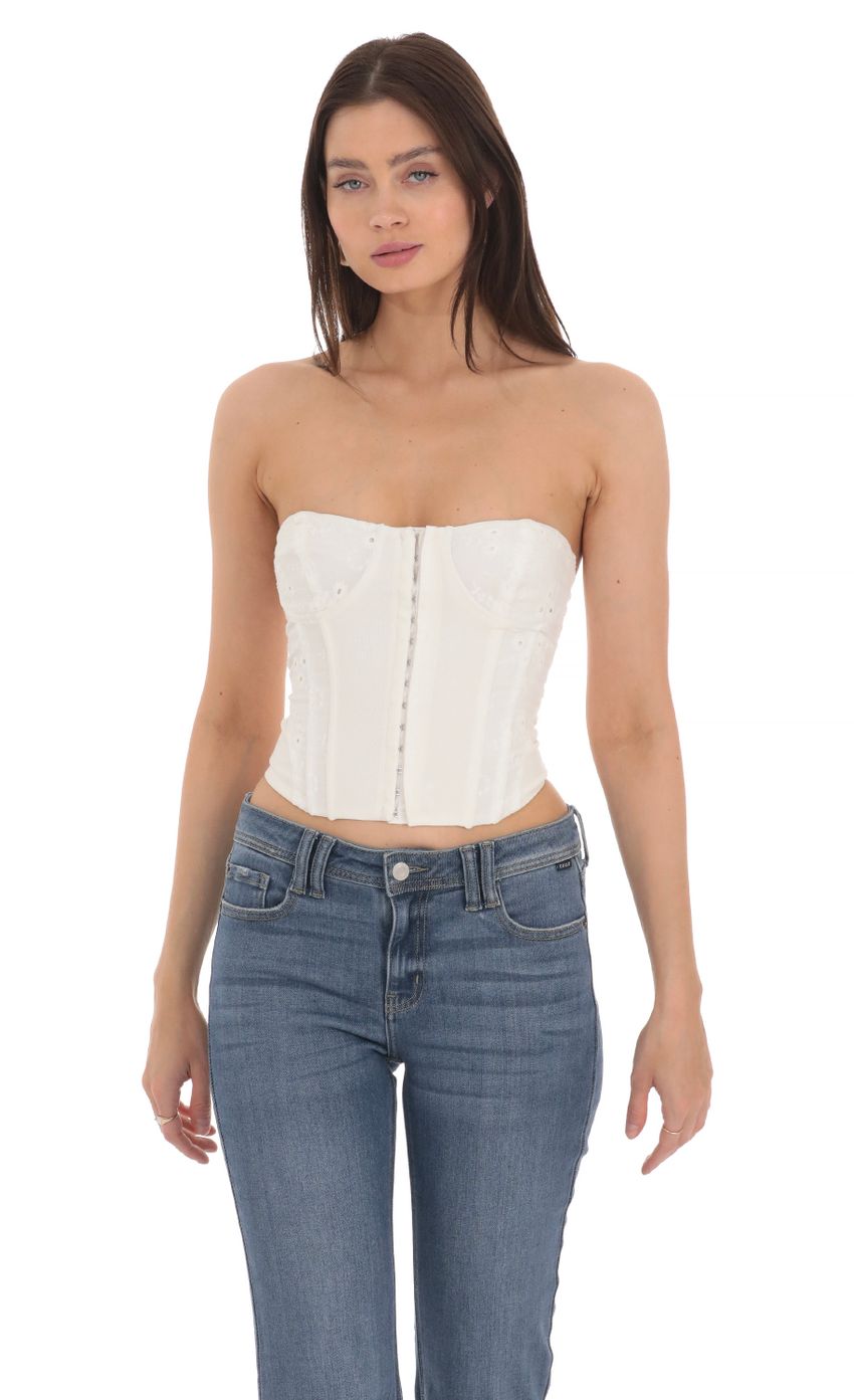 Picture Floral Eyelet Corset Top in White. Source: https://media-img.lucyinthesky.com/data/Apr24/850xAUTO/379c6e3f-06a3-4367-bb0b-34bfe53b0d86.jpg