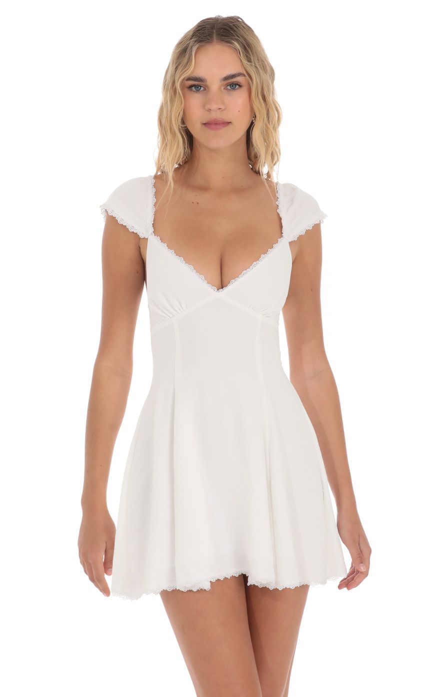 Picture Lace Trim Cap Sleeve Dress in White. Source: https://media-img.lucyinthesky.com/data/Apr24/850xAUTO/5e99f2e1-9311-4b51-aabd-452fab152cbf.jpg