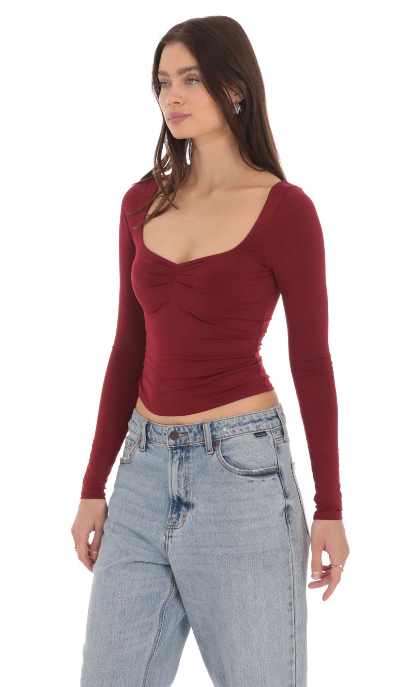 Picture Fitted Long Sleeve Top in Maroon. Source: https://media-img.lucyinthesky.com/data/Apr24/850xAUTO/61f335ce-dd1e-4a18-bfce-67eec65d450e.jpg