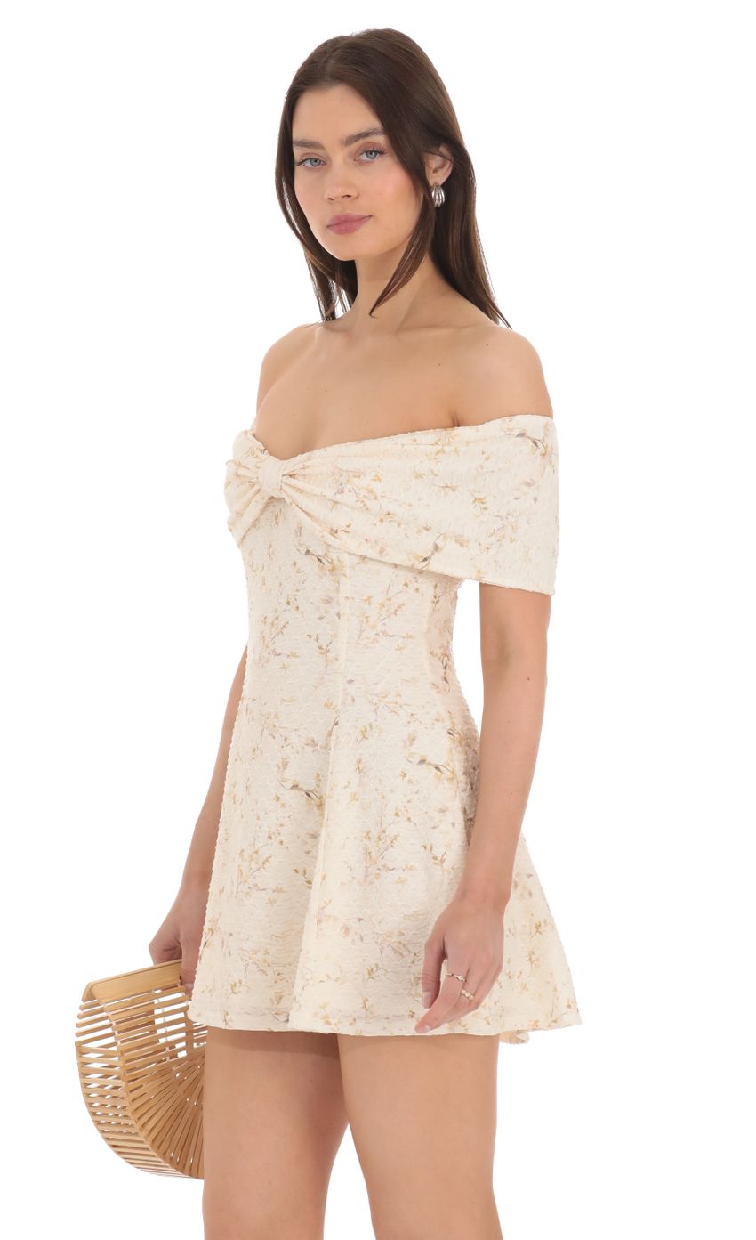 Picture Front Bow Floral Off Shoulder Dress in Cream. Source: https://media-img.lucyinthesky.com/data/Apr24/850xAUTO/848a6ba1-3349-498a-bcc0-c885ebcc87bd.jpg