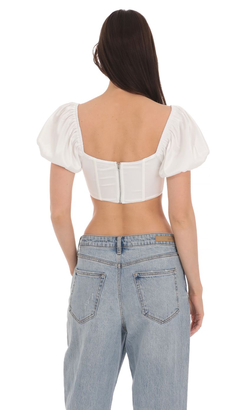 Picture Satin Puff Sleeve Corset Top in White. Source: https://media-img.lucyinthesky.com/data/Apr24/850xAUTO/bd21544f-00b2-4621-b8fe-b23493cabc5a.jpg