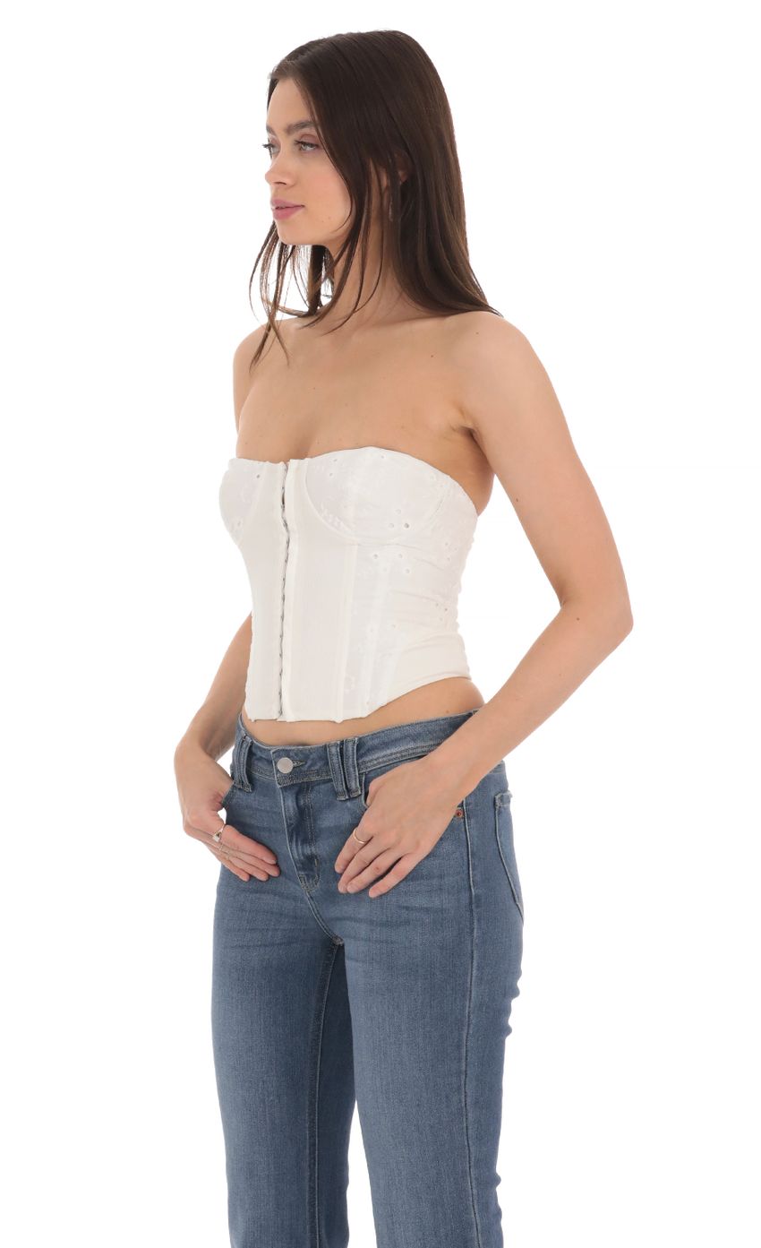 Picture Floral Eyelet Corset Top in White. Source: https://media-img.lucyinthesky.com/data/Apr24/850xAUTO/c1d7126a-c845-4558-b360-e4bf1f83d36c.jpg