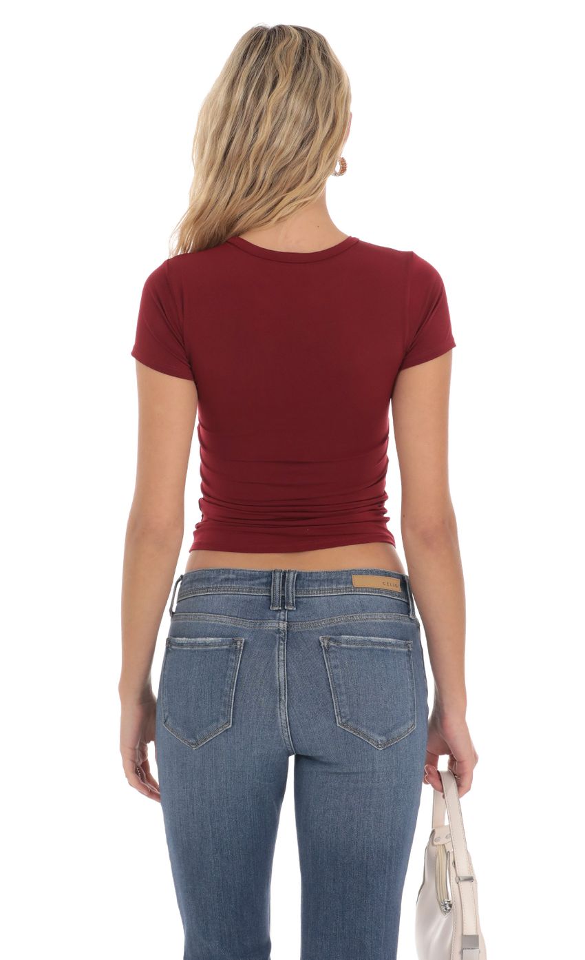Picture Stretch Short Sleeve Top in Maroon. Source: https://media-img.lucyinthesky.com/data/Apr24/850xAUTO/cdd2d45c-b39f-4be7-9ea1-48483bbd5b78.jpg