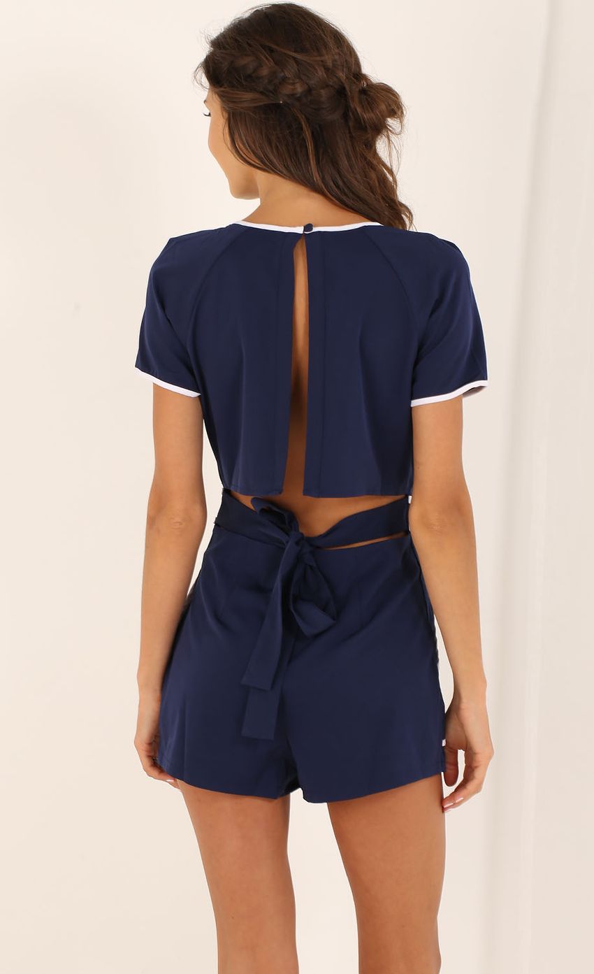Picture White-Trimmed Playsuit in Navy Blue. Source: https://media-img.lucyinthesky.com/data/Aug15_2/850xAUTO/0Y5A7440.JPG