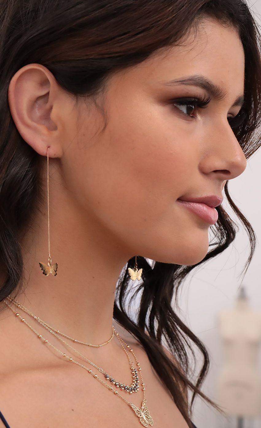 Picture Dainty Butterfly Earrings in Gold. Source: https://media-img.lucyinthesky.com/data/Aug20_2/850xAUTO/781A9629.JPG