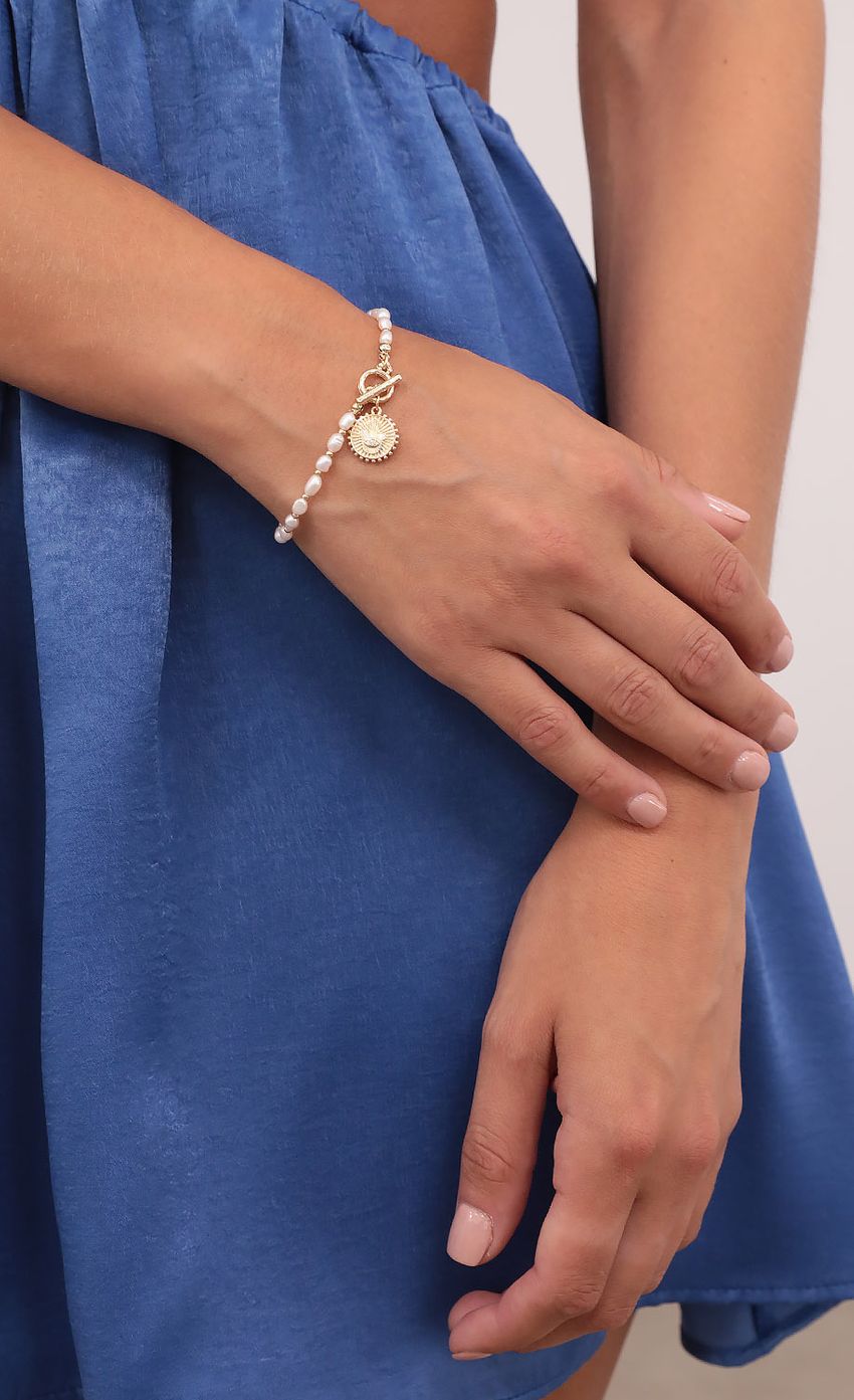Picture In The Hamsa Hand Pearl Bracelet in Gold. Source: https://media-img.lucyinthesky.com/data/Aug21_2/850xAUTO/1V9A4224.JPG