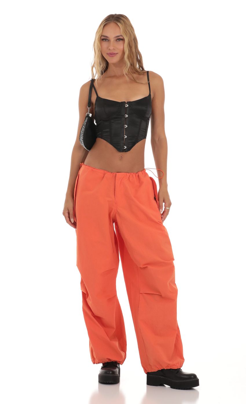 Picture Tyche Wide Leg Parachute Pants in Orange. Source: https://media-img.lucyinthesky.com/data/Aug23/850xAUTO/0791e163-8d7c-4c0e-b3ed-64eee902d2ef.jpg