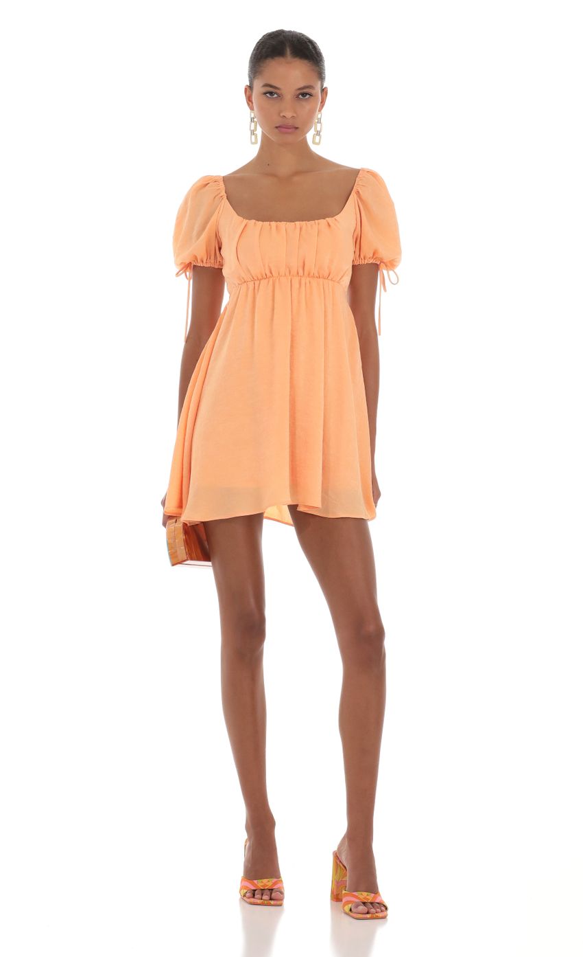 Picture Baby Doll Dress in Orange. Source: https://media-img.lucyinthesky.com/data/Aug23/850xAUTO/13a60cda-2942-4ffe-be6a-efe77a738c38.jpg