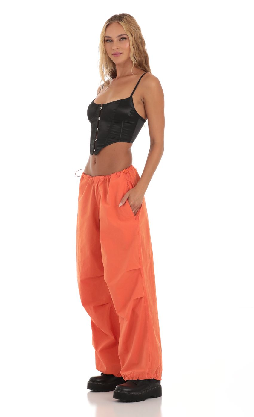 Picture Tyche Wide Leg Parachute Pants in Orange. Source: https://media-img.lucyinthesky.com/data/Aug23/850xAUTO/3ccfa11f-7ddb-4d6a-bd17-720ba5f92b9a.jpg