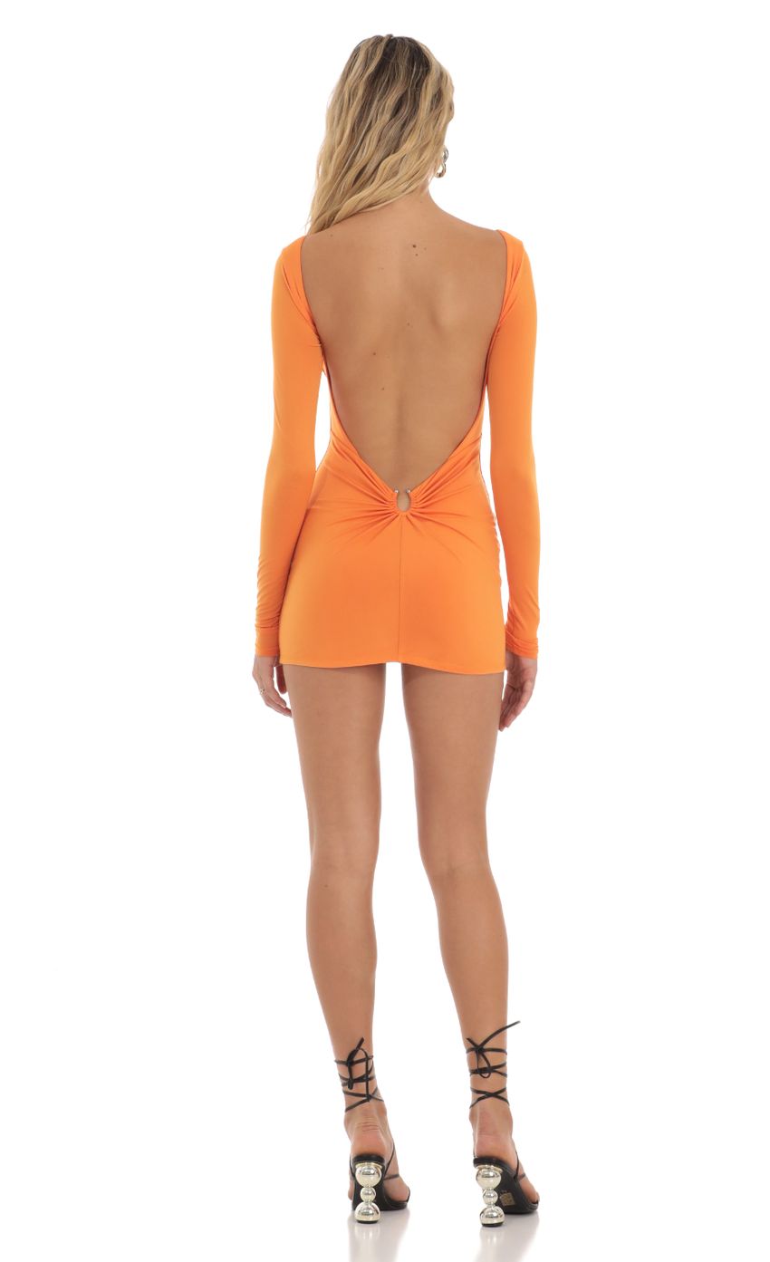 Picture Open Back Dress in Orange. Source: https://media-img.lucyinthesky.com/data/Aug23/850xAUTO/49305c80-1f85-440b-b1bd-48a9eae92436.jpg