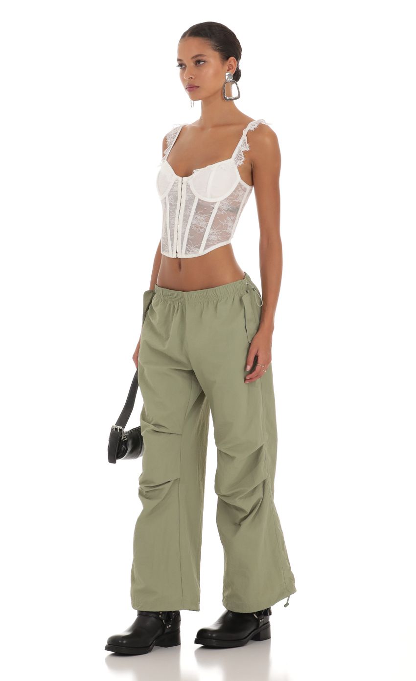 Picture Low Rise Parachute Pants in Green. Source: https://media-img.lucyinthesky.com/data/Aug23/850xAUTO/66eb7e90-d896-46b1-b55c-48be0aeca5dd.jpg