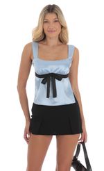 Picture Satin Bow Top in Blue. Source: https://media-img.lucyinthesky.com/data/Aug24/150xAUTO/c86a7f0d-13ec-4025-9d6f-30ee538262d1.jpg