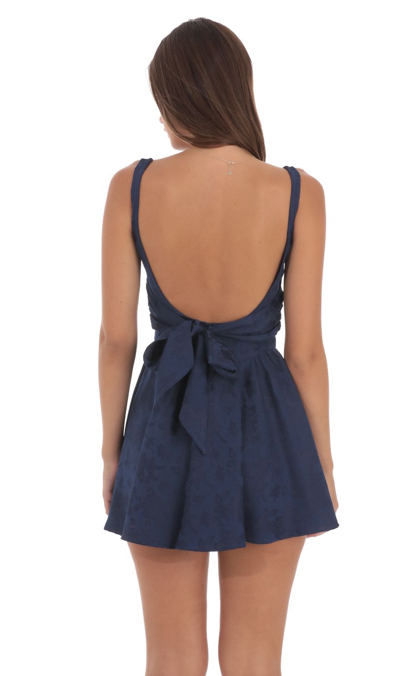 Picture Floral Jacquard Open Back Bow Dress in Navy. Source: https://media-img.lucyinthesky.com/data/Aug24/850xAUTO/af371f0b-5008-4690-8aaf-c4666f18b455.jpg