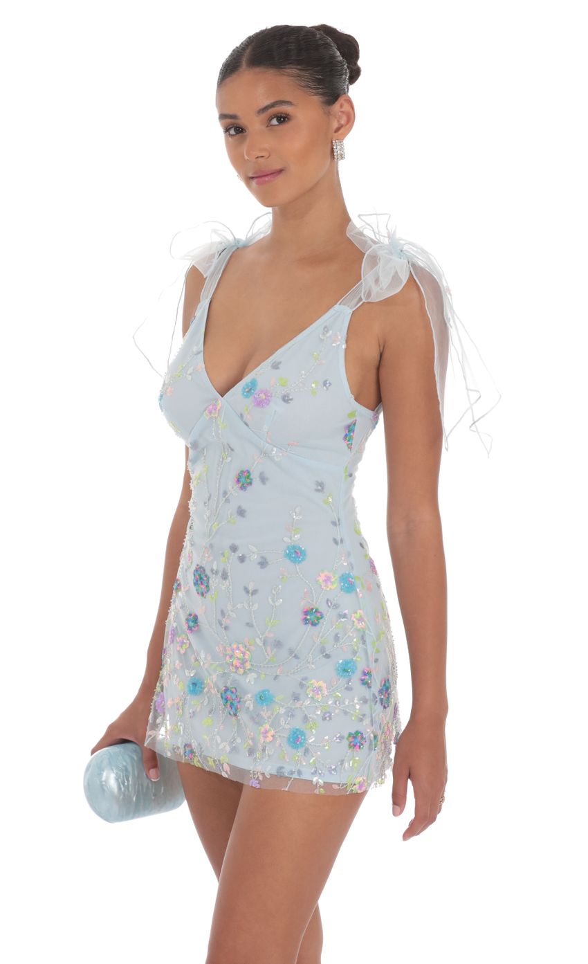 Picture Floral Sequin V-Neck Dress in Blue. Source: https://media-img.lucyinthesky.com/data/Aug24/850xAUTO/bbbef273-79b5-4a72-944e-c3cabcc344ac.jpg