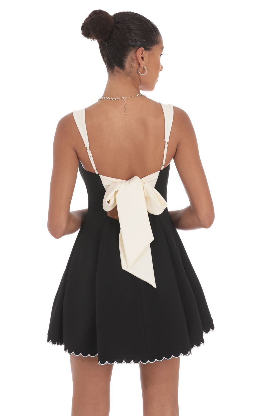 Picture Scallop Hem Fit and Flare Dress in Black. Source: https://media-img.lucyinthesky.com/data/Aug24/850xAUTO/ee7175d2-0678-4c8c-8bbf-69e2d9bada18.jpg