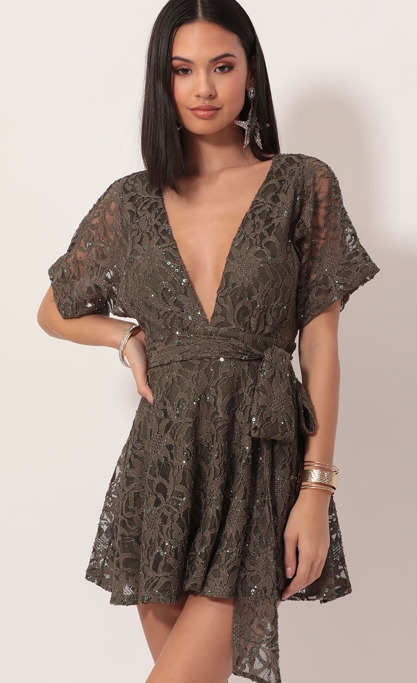 Picture Feeling the Night Sequin Lace Dress in Olive. Source: https://media-img.lucyinthesky.com/data/Dec19_1/850xAUTO/781A8252.JPG