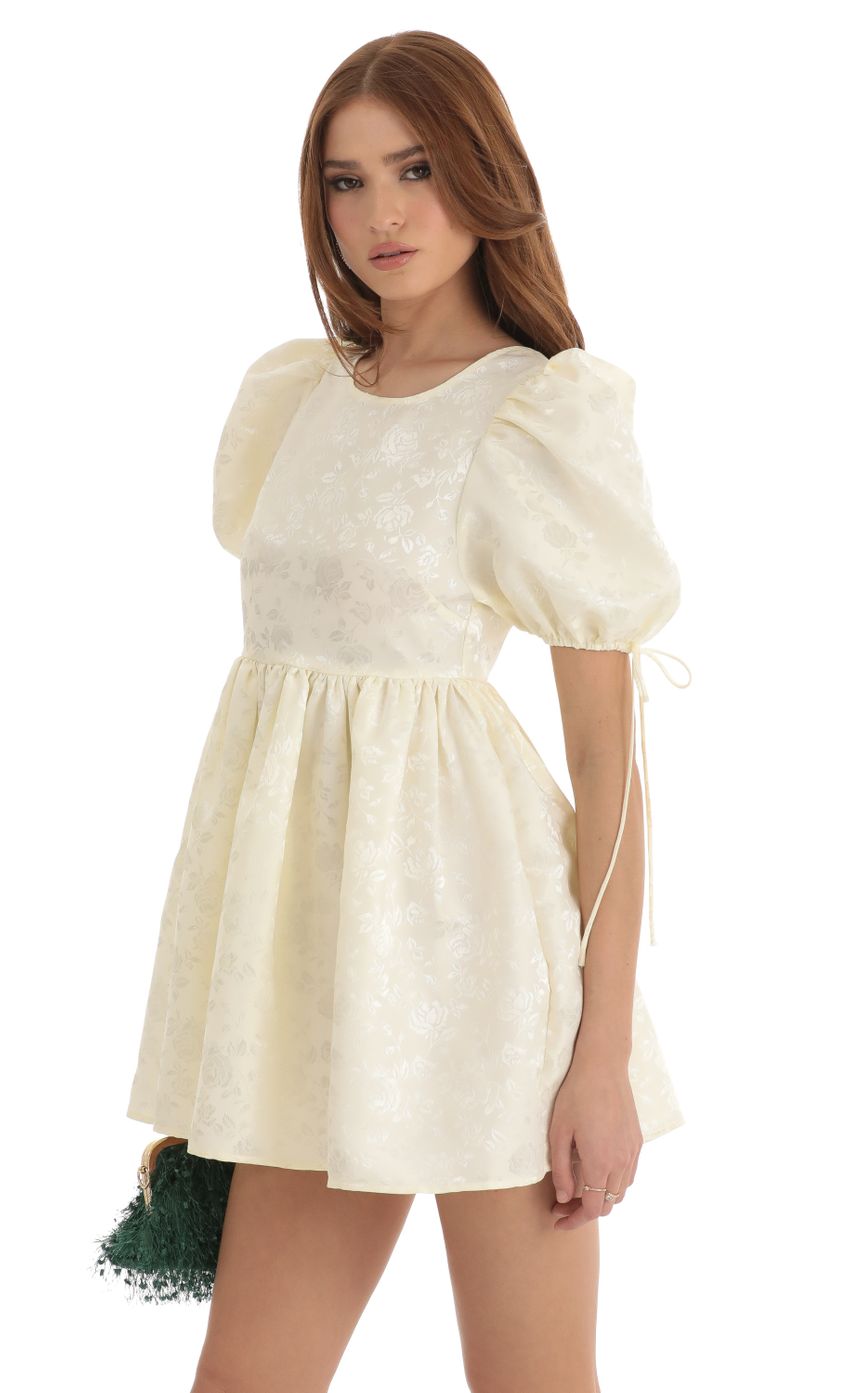 Picture Floral Jacquard Baby Doll Dress in Cream. Source: https://media-img.lucyinthesky.com/data/Dec22/850xAUTO/3689cb70-3c93-45c4-b618-be6fe786a9e0.jpg