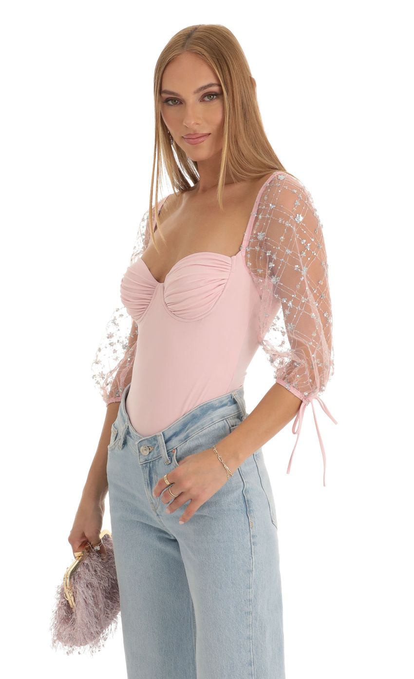 Picture Sequin Puff Sleeve Bodysuit in Pink. Source: https://media-img.lucyinthesky.com/data/Dec22/850xAUTO/aa6228e3-feb8-4117-821f-cfd3930ec9b5.jpg