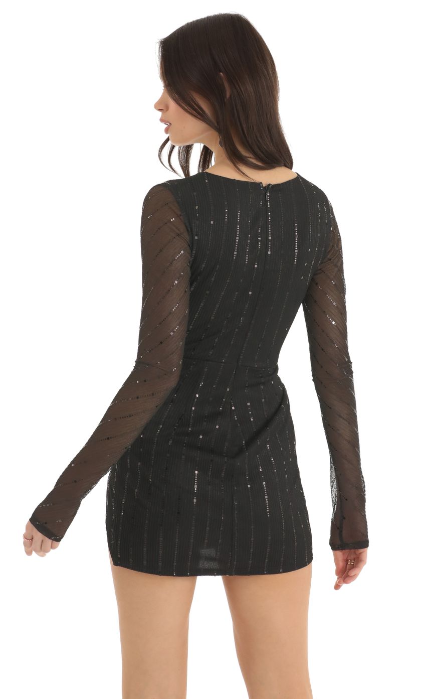 Picture Striped Sequin Long Sleeve Dress in Black. Source: https://media-img.lucyinthesky.com/data/Dec22/850xAUTO/d0c58de6-4d12-4ed6-a00e-62b8262b69b7.jpg