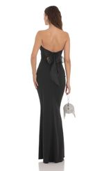 Picture Back Bow Strapless Maxi Dress in Black. Source: https://media-img.lucyinthesky.com/data/Dec23/150xAUTO/520cc516-b83f-4f81-810c-a9cec811d3ab.jpg