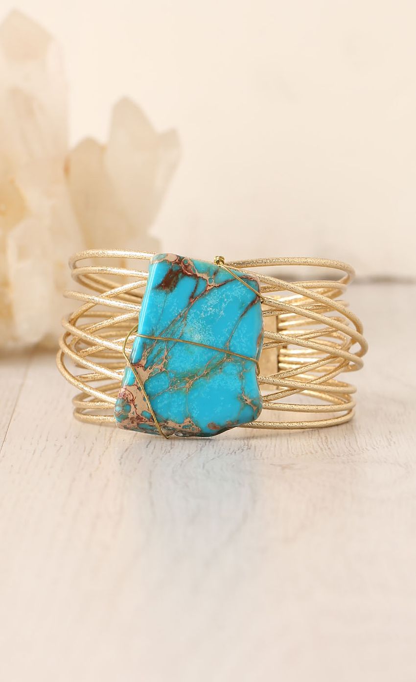 Picture Gold Stencil Cuff with Blue Stone. Source: https://media-img.lucyinthesky.com/data/Feb15_2/850xAUTO/0Y5A5054.JPG