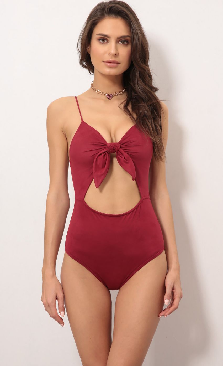 Picture Noir Suede Front Tie Bodysuit in Wine. Source: https://media-img.lucyinthesky.com/data/Feb18_2/850xAUTO/0Y5A5996.JPG