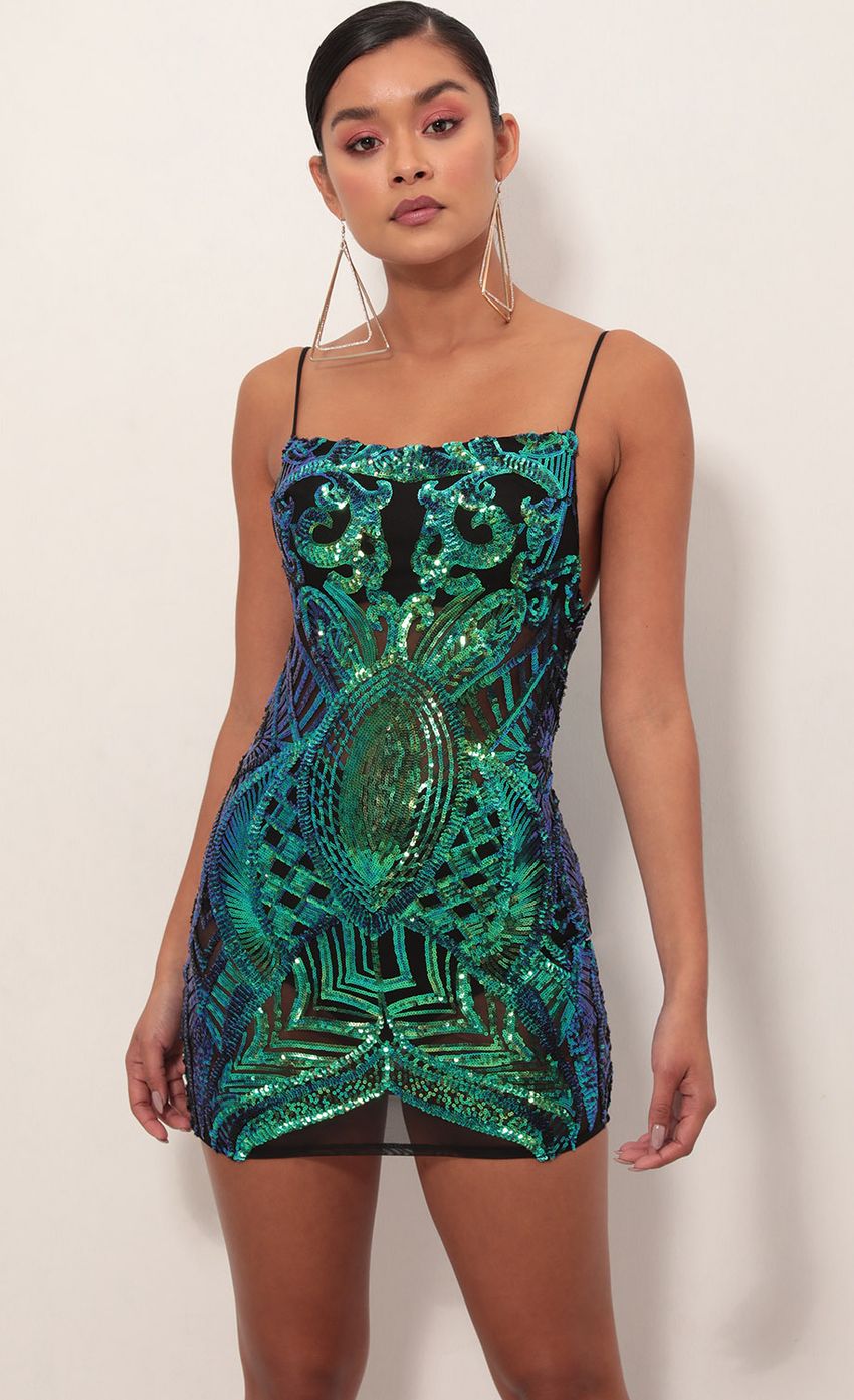 Picture Vegas Sequin Mesh Dress in Black Turquoise. Source: https://media-img.lucyinthesky.com/data/Feb19_2/850xAUTO/781A4634S.JPG