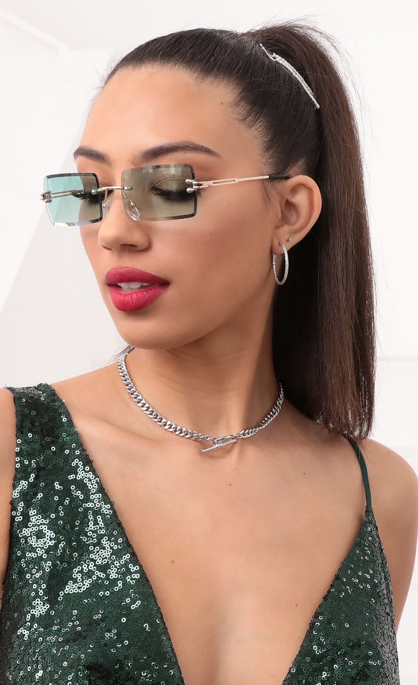 Picture 90s Baby Rectangle Sunglasses in Aqua. Source: https://media-img.lucyinthesky.com/data/Feb21_1/850xAUTO/1V9A2399.JPG