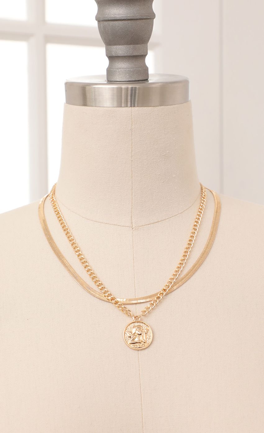 Picture Cherub Layered Necklace in Gold. Source: https://media-img.lucyinthesky.com/data/Feb21_1/850xAUTO/AT2A92631.JPG