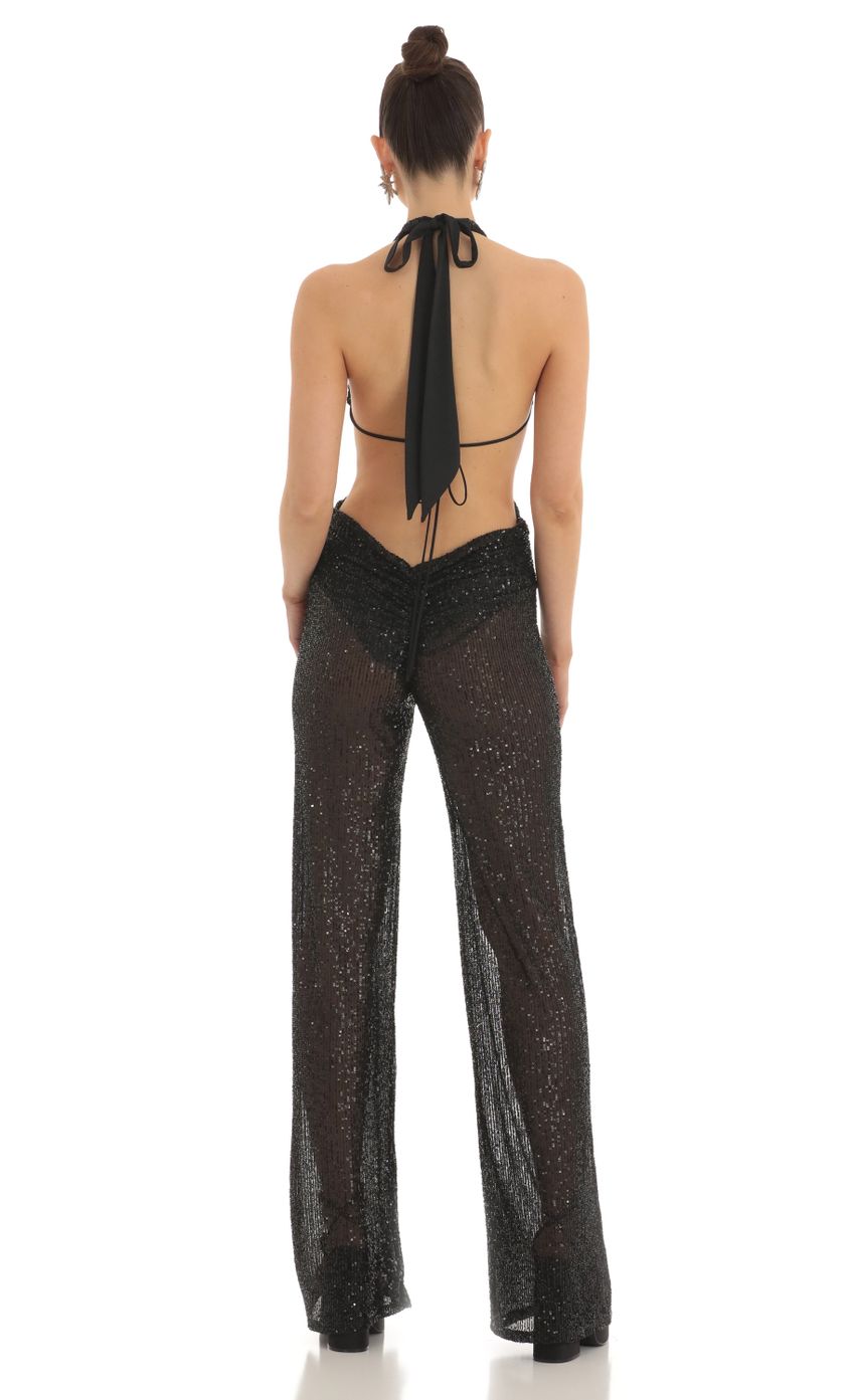 Picture Sequin Plunge Halter Jumpsuit in Black. Source: https://media-img.lucyinthesky.com/data/Feb23/850xAUTO/928d5daf-baf7-497e-a011-2da2babd1d81.jpg