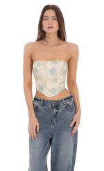 Picture Floral Embroidered Corset Top on Cream. Source: https://media-img.lucyinthesky.com/data/Feb24/150xAUTO/554ee24b-066a-40e1-b3ce-59f4205b3ff0.jpg