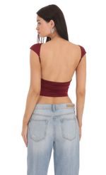 Picture High Neck Open Back Top in Maroon. Source: https://media-img.lucyinthesky.com/data/Feb24/150xAUTO/898cd572-d733-41b9-819c-e926b523318f.jpg