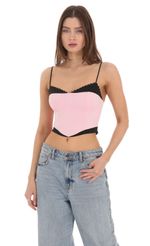 Picture Black Trim Crop Top in Pink. Source: https://media-img.lucyinthesky.com/data/Feb24/150xAUTO/bcd33f31-767f-4511-8303-6aa6df5e1407.jpg
