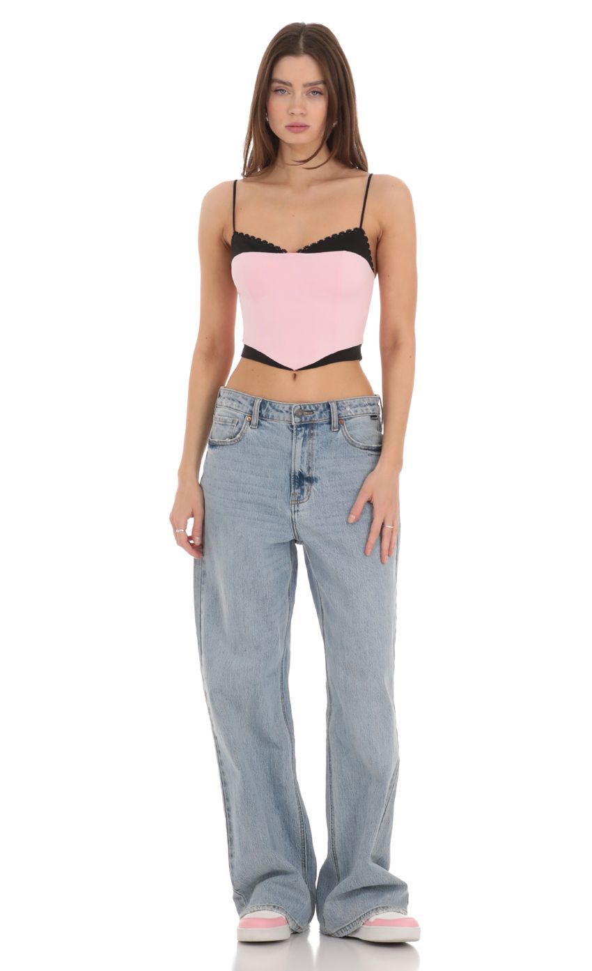 Picture Black Trim Crop Top in Pink. Source: https://media-img.lucyinthesky.com/data/Feb24/850xAUTO/2094786e-5909-45c2-8625-4e059521479c.jpg