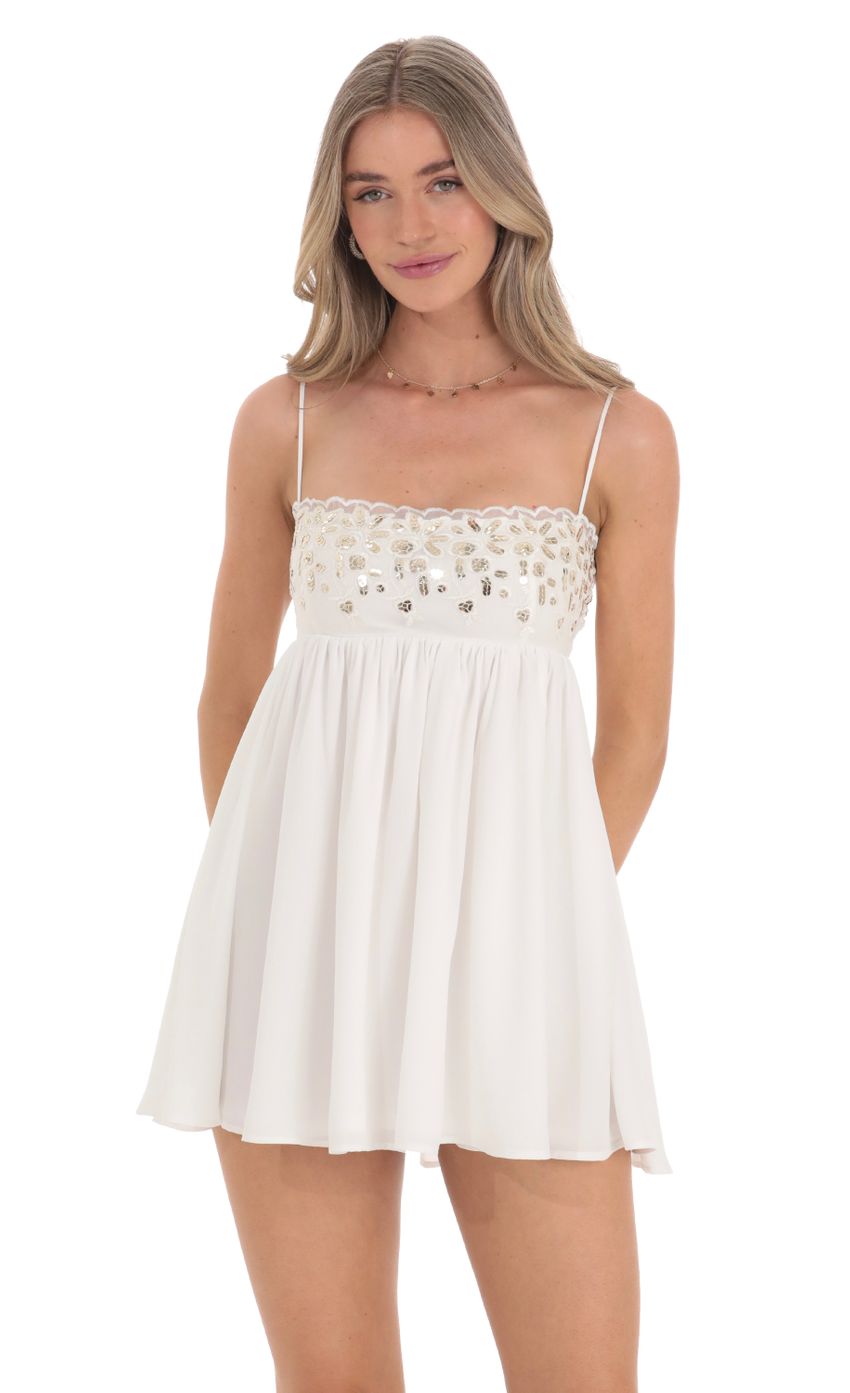 Picture Sequin Embroidered Babydoll Dress in White. Source: https://media-img.lucyinthesky.com/data/Feb24/850xAUTO/2b453101-0352-4128-bf61-1145840a51c0.jpg
